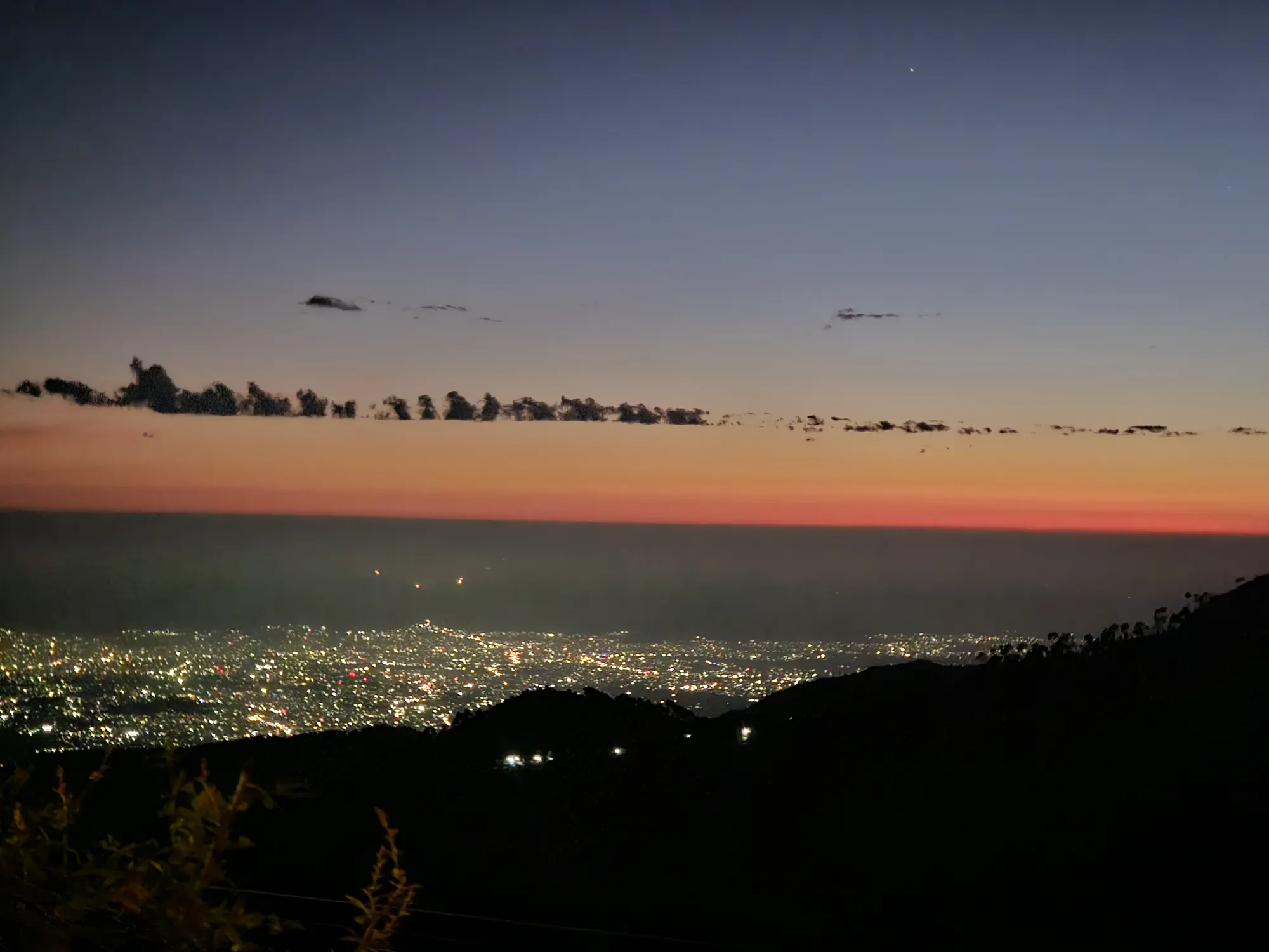 The lights of Dehradun glittering in the Doon Valley below the Mussoorie hills after sunset
