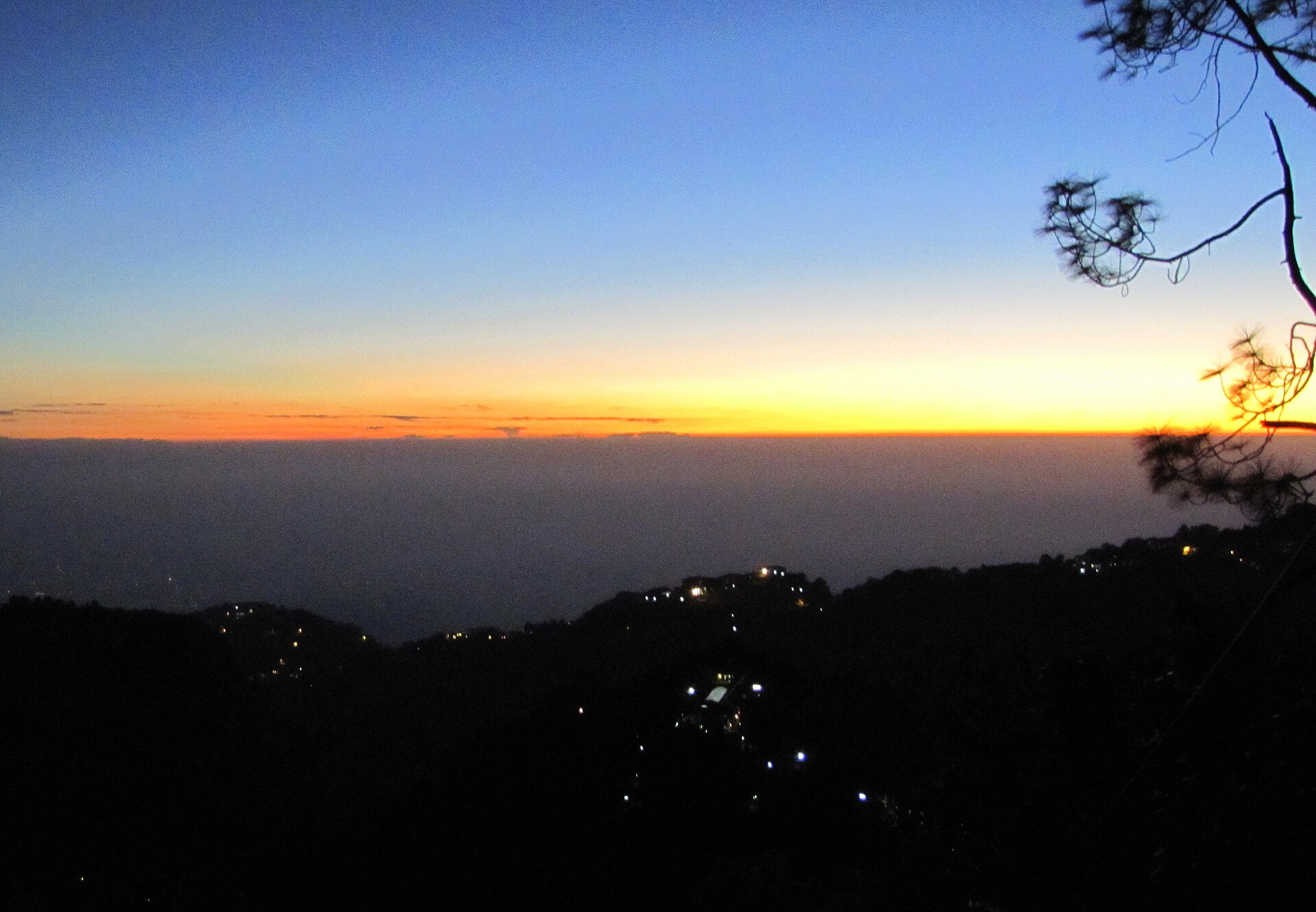 Winterline above the Dehradun valley seen from Mussoorie, a bright orange line above the dark plains at dusk